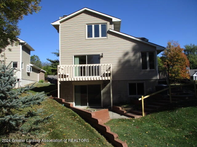 rear view of house with a yard