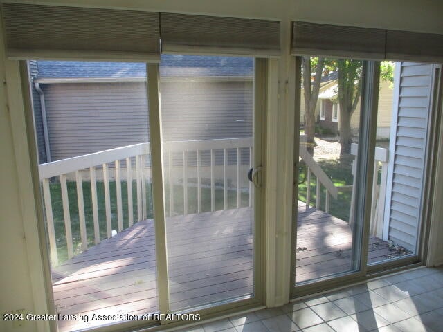 doorway featuring light tile patterned floors and plenty of natural light