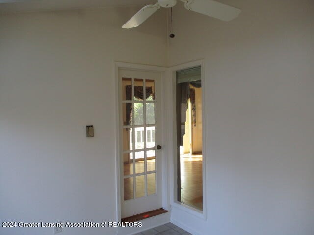 view of exterior entry featuring ceiling fan