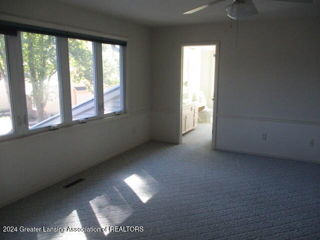 carpeted spare room with ceiling fan