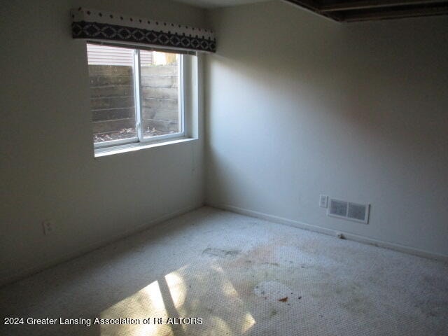 unfurnished room featuring carpet flooring