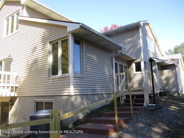 view of side of property with central air condition unit