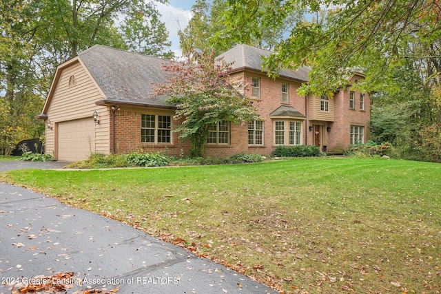 view of front of home with a front yard and a garage