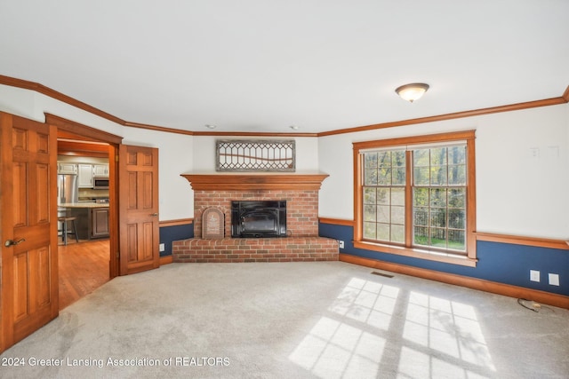 unfurnished living room with light colored carpet, a fireplace, and crown molding