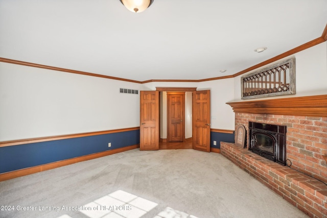 unfurnished living room featuring carpet floors, a brick fireplace, and crown molding