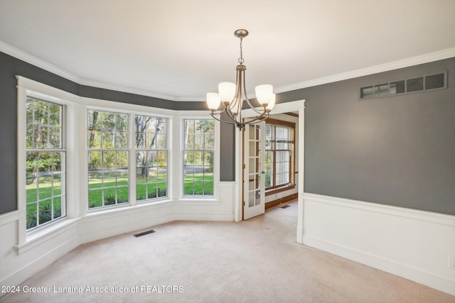 unfurnished dining area with crown molding, carpet flooring, and a healthy amount of sunlight