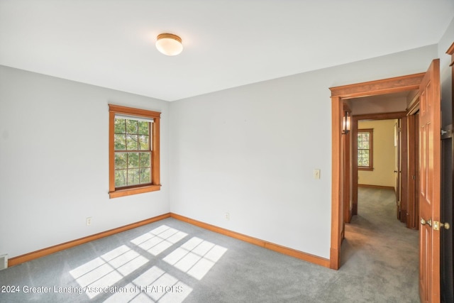 spare room with light colored carpet