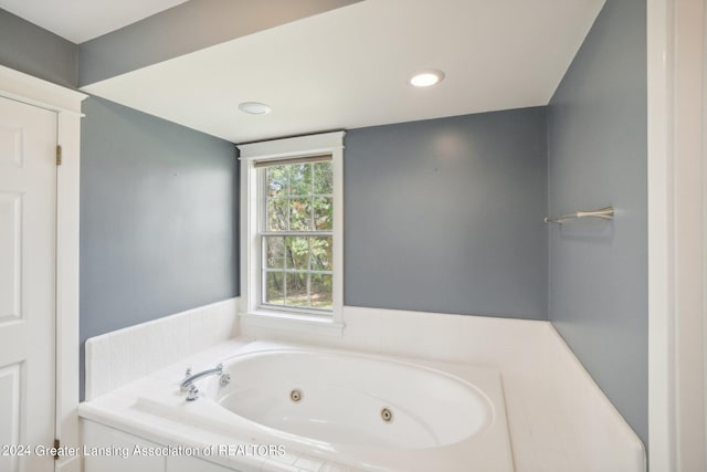 bathroom featuring tiled tub