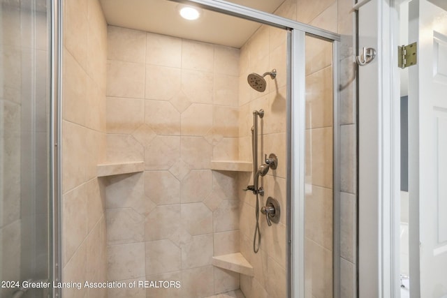 bathroom featuring a shower with shower door