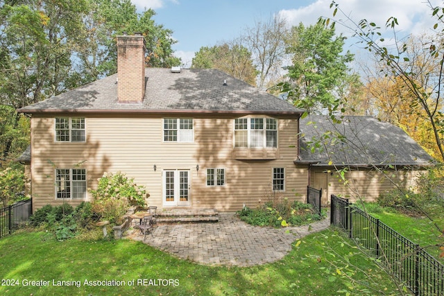 rear view of house with a yard and a patio area