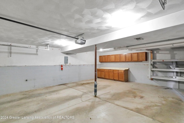 garage featuring a garage door opener and electric panel