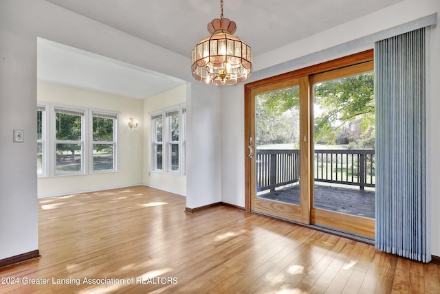 interior space with a notable chandelier and hardwood / wood-style flooring