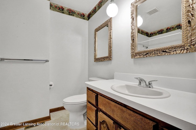 bathroom featuring vanity, toilet, and tile patterned floors