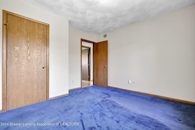 unfurnished bedroom with carpet floors