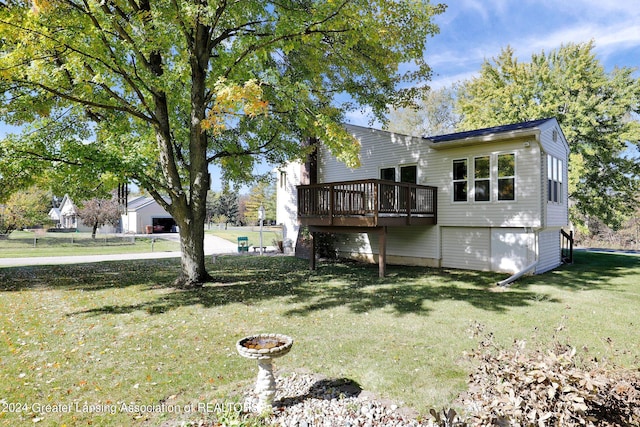 back of house with a wooden deck and a yard