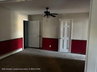 empty room with a baseboard radiator, carpet floors, and ceiling fan