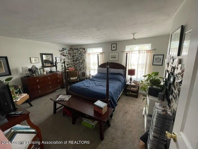 bedroom with a textured ceiling and carpet