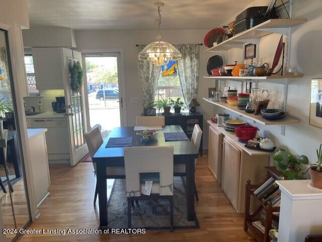 dining area featuring light hardwood / wood-style flooring and a notable chandelier