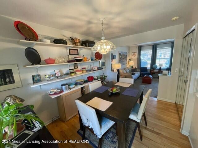 dining area featuring an inviting chandelier and light wood-type flooring