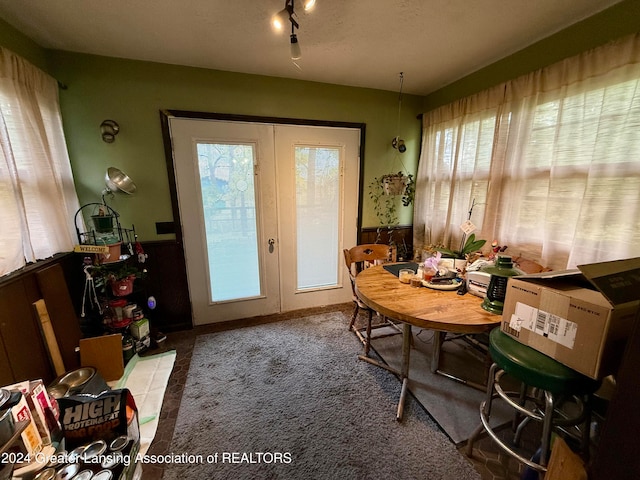 carpeted dining room featuring french doors