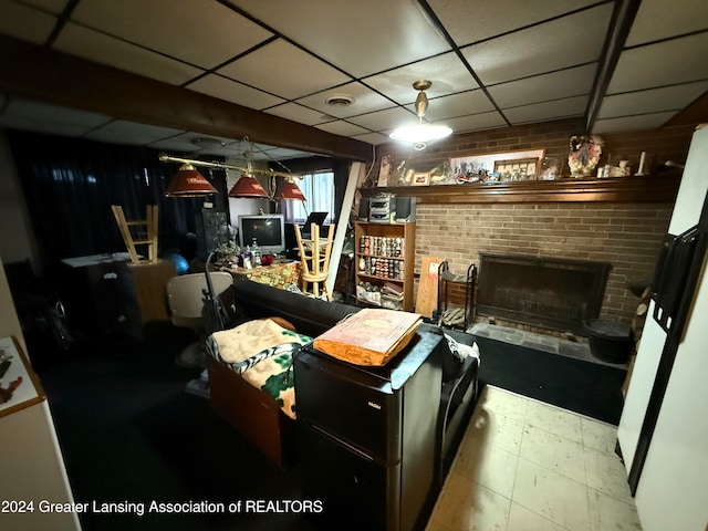 basement with a fireplace and a paneled ceiling