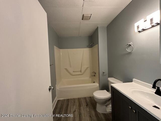 full bathroom featuring toilet, shower / tub combination, vanity, and hardwood / wood-style floors