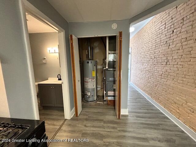 utility room with heating unit and gas water heater