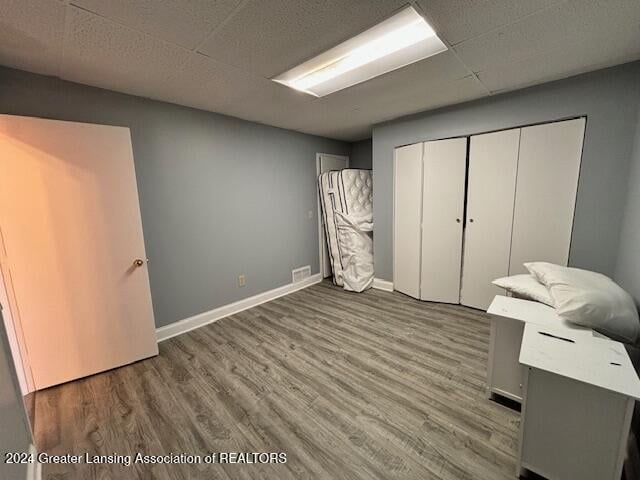 unfurnished bedroom featuring hardwood / wood-style floors and a closet