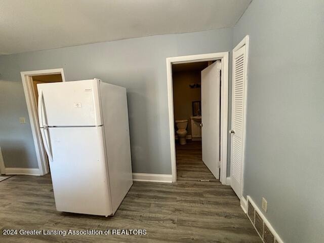 kitchen featuring white fridge and dark hardwood / wood-style flooring