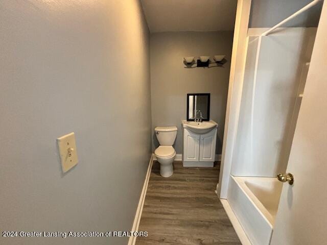 full bathroom with vanity, toilet, shower / washtub combination, and hardwood / wood-style floors