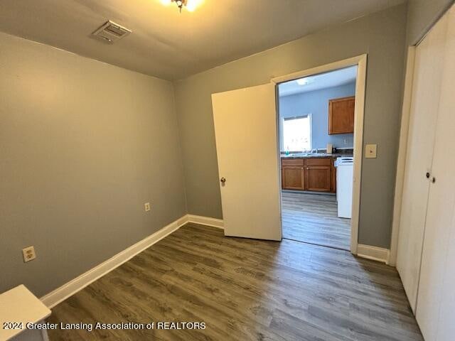 unfurnished room with dark hardwood / wood-style flooring