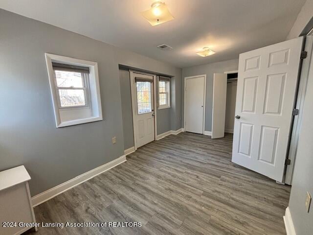 unfurnished bedroom featuring dark hardwood / wood-style flooring