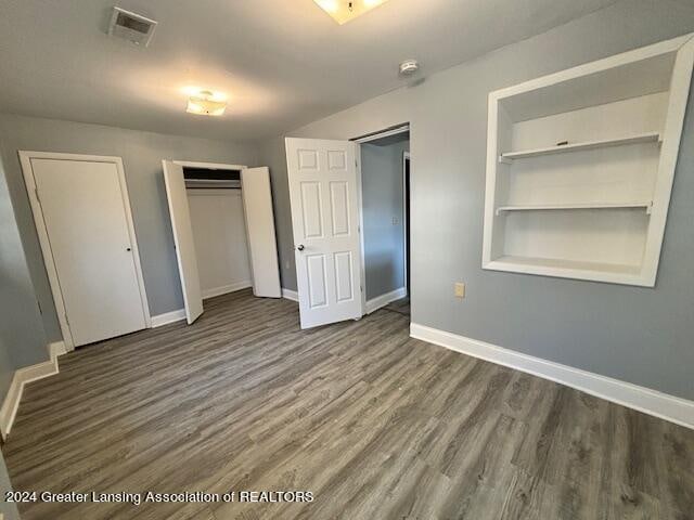 unfurnished bedroom featuring dark hardwood / wood-style flooring