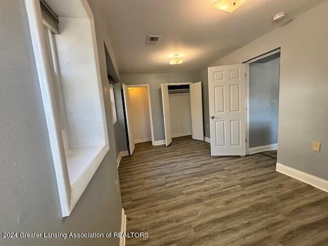 unfurnished bedroom with dark hardwood / wood-style flooring