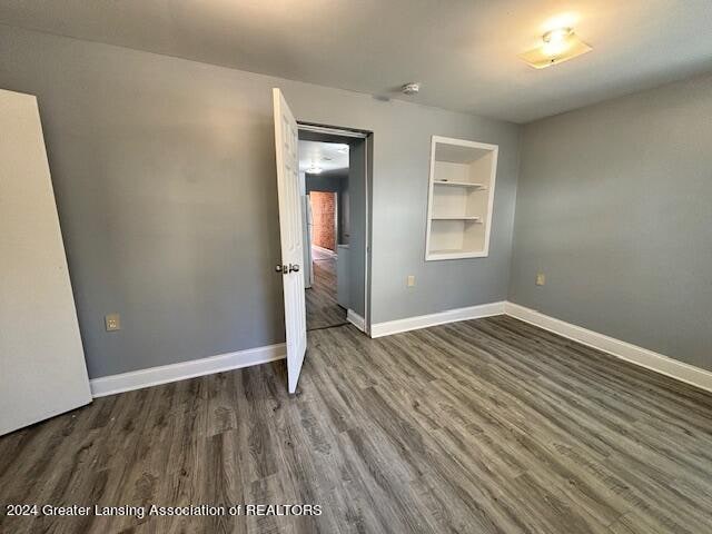 unfurnished bedroom featuring dark hardwood / wood-style floors