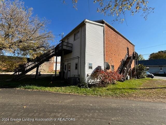 view of property exterior with central AC unit