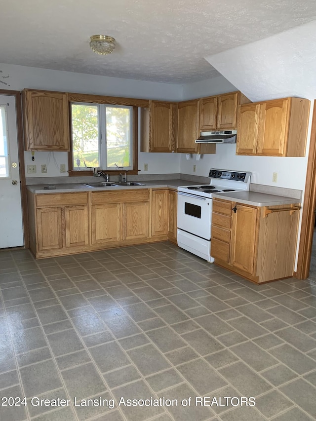 kitchen featuring sink, a textured ceiling, and electric range