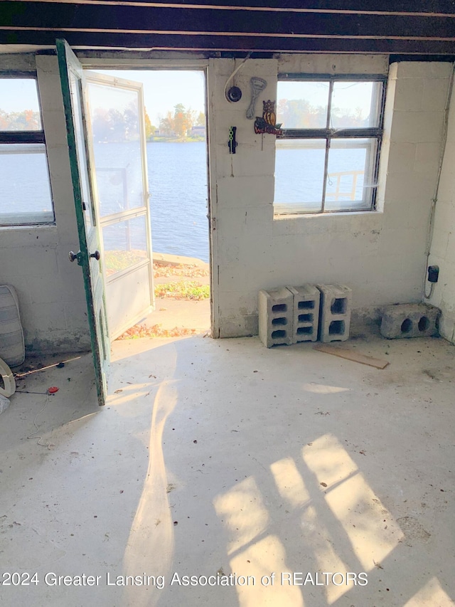 empty room featuring a water view and a wealth of natural light