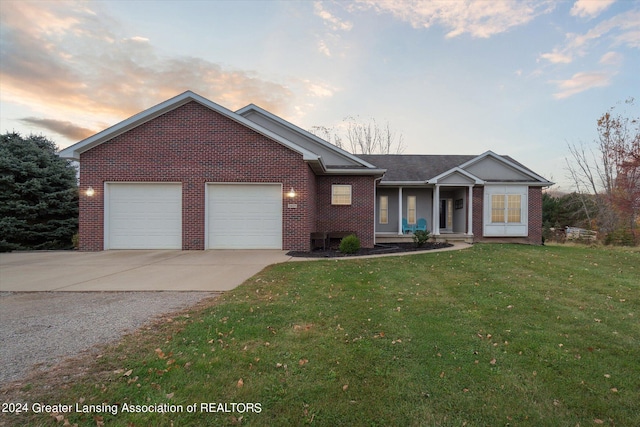 view of front of house with a yard and a garage