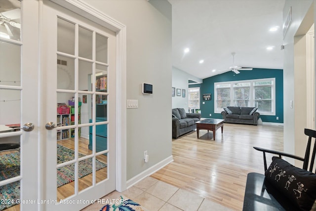 interior space featuring lofted ceiling, french doors, and light wood-type flooring