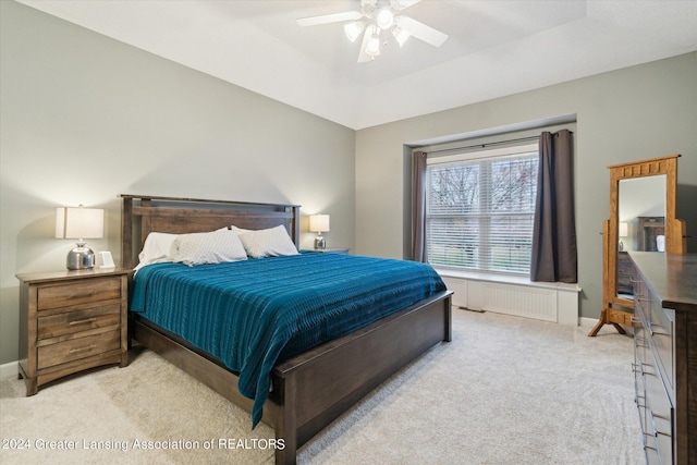 bedroom with ceiling fan and light colored carpet