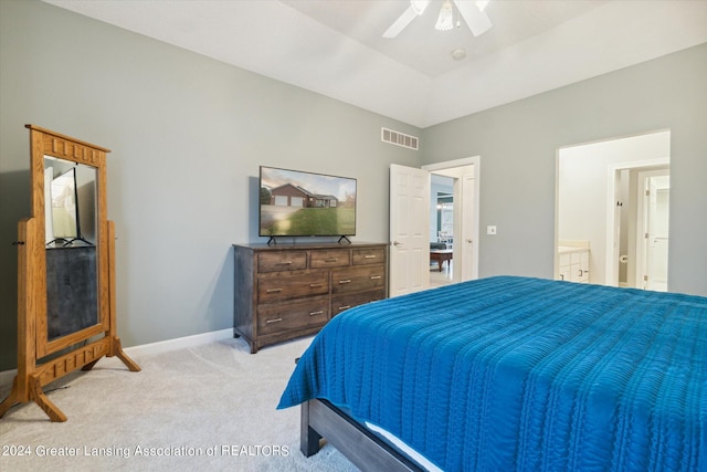 bedroom featuring light carpet, ensuite bath, and ceiling fan