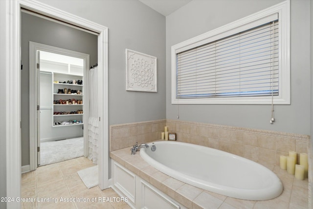 bathroom with a bathtub and tile patterned flooring