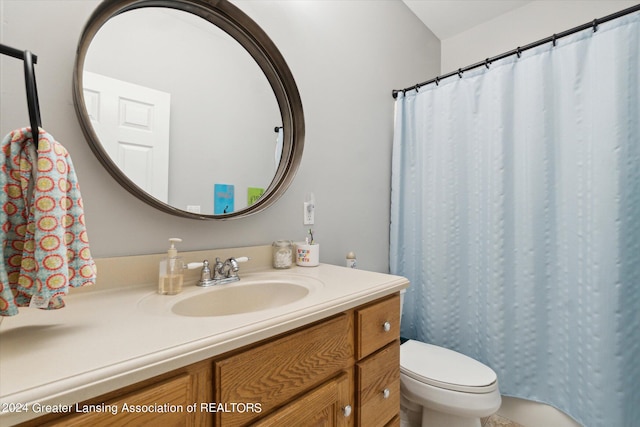 bathroom with vanity, toilet, and a shower with curtain