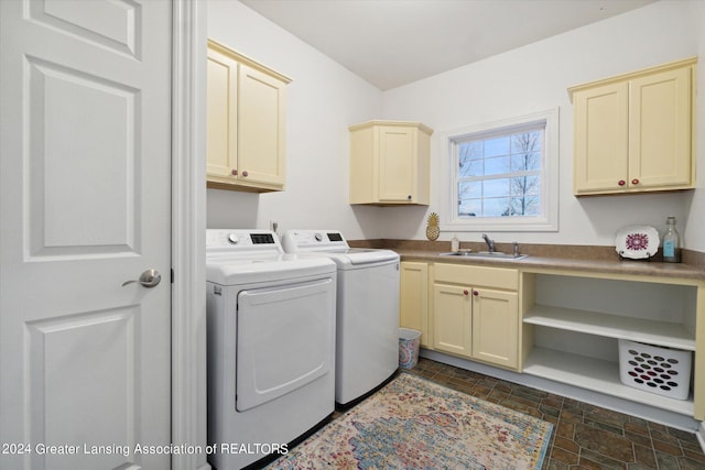 laundry room with sink, cabinets, and separate washer and dryer