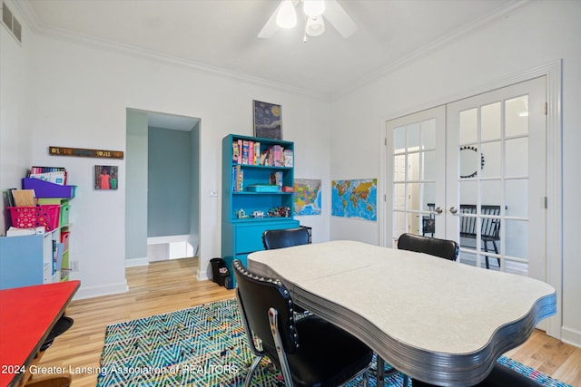 dining space with ornamental molding, french doors, hardwood / wood-style floors, and ceiling fan