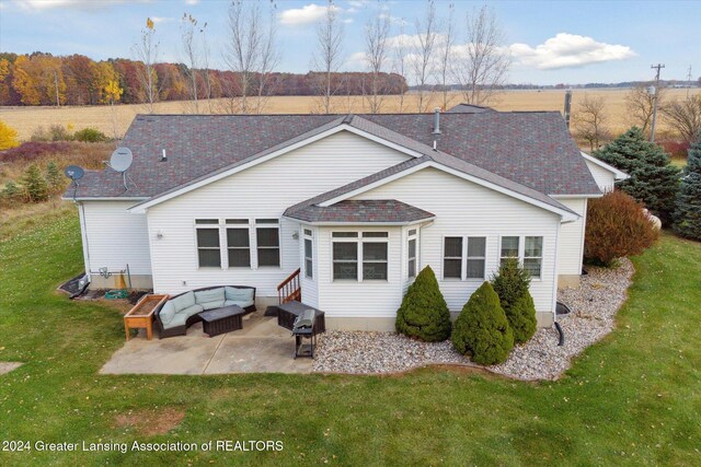 back of property with a patio, outdoor lounge area, and a lawn