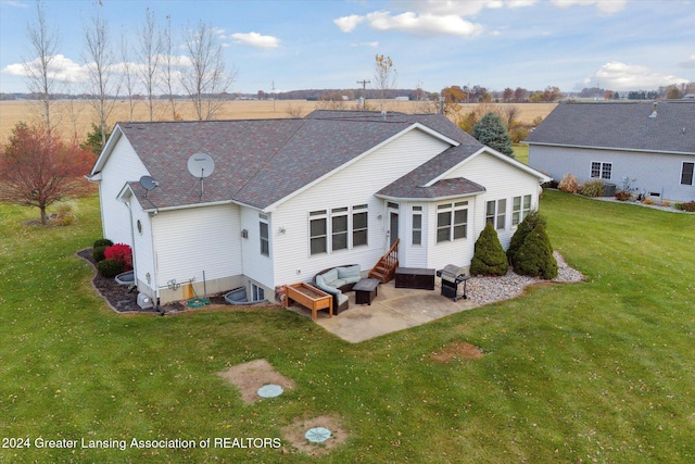 back of house with a patio and a lawn