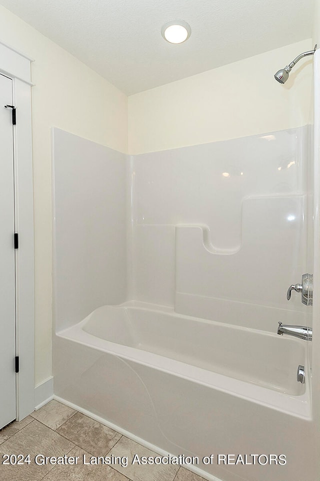 bathroom with tile patterned flooring and  shower combination