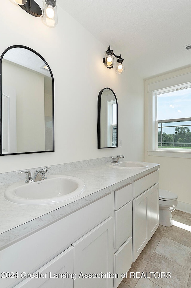 bathroom featuring tile patterned floors, toilet, and vanity